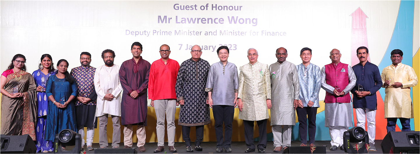Group of people on stage, some holding awards, with Mr. Lawrence Wong in the center.